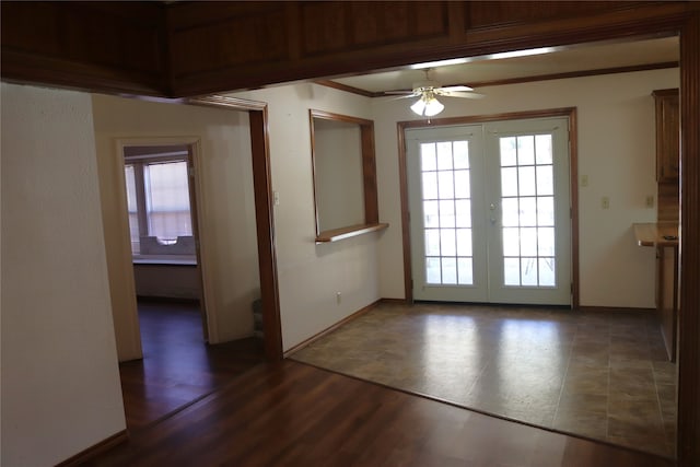 entryway featuring dark wood-type flooring, ceiling fan, crown molding, and french doors