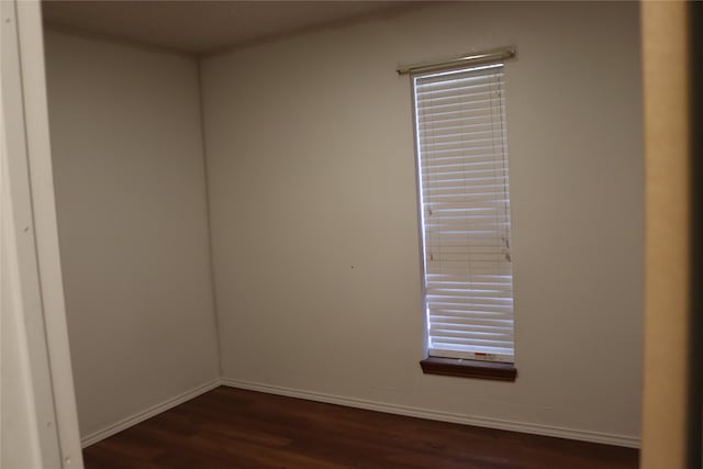 empty room with dark hardwood / wood-style floors