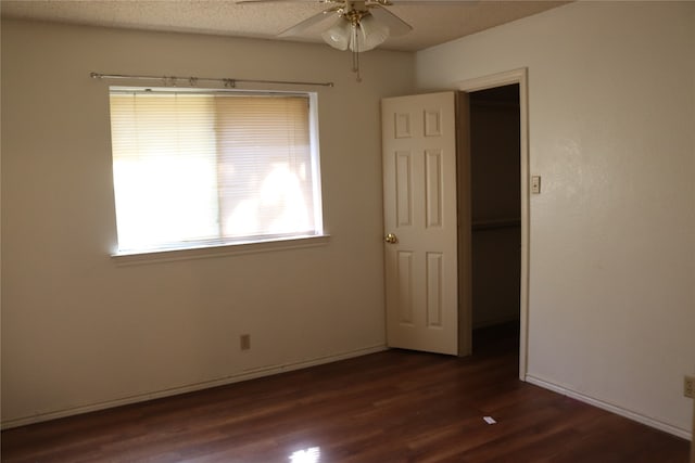 empty room featuring ceiling fan and dark hardwood / wood-style floors