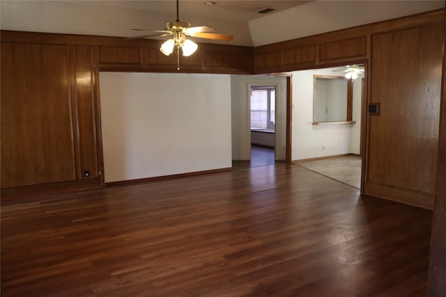 unfurnished room featuring ceiling fan, lofted ceiling, and dark hardwood / wood-style flooring