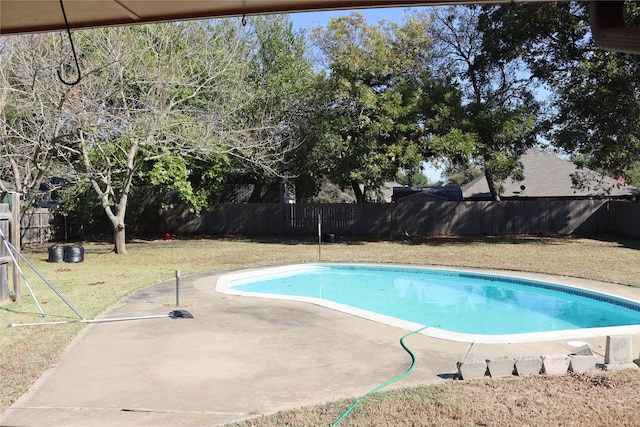 view of swimming pool featuring a patio and a lawn