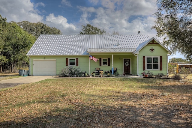 ranch-style house with a porch, a front yard, and a garage