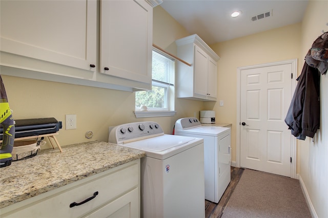 washroom with dark colored carpet, separate washer and dryer, and cabinets