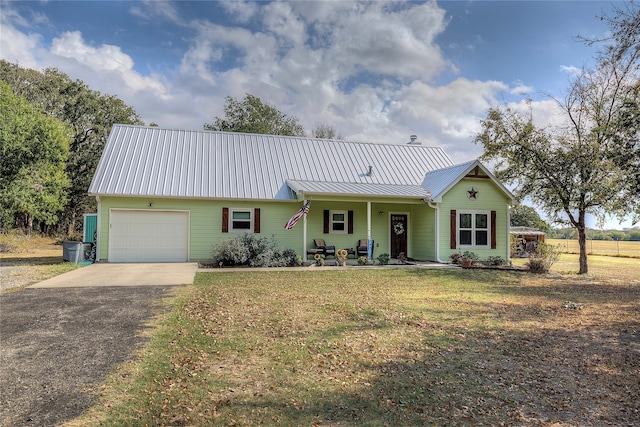 ranch-style house with a porch, a front lawn, and a garage