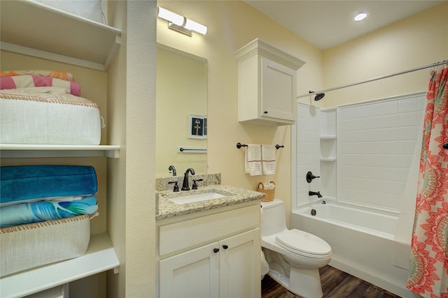 full bathroom with vanity, hardwood / wood-style floors, shower / bath combo with shower curtain, and toilet