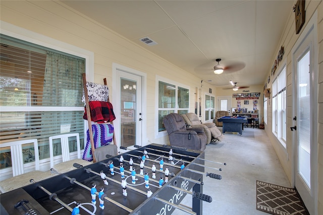 interior space with ceiling fan