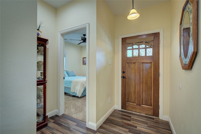 entryway with ceiling fan and dark hardwood / wood-style flooring