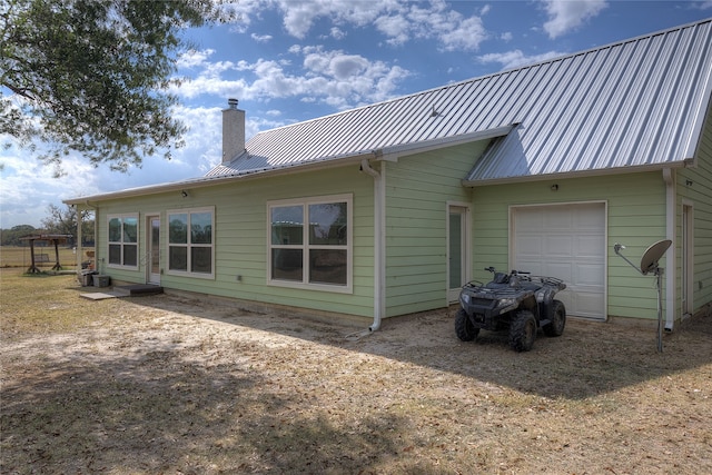 rear view of property featuring a garage