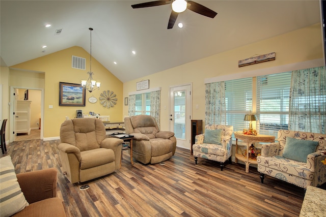 living room with dark wood-type flooring, ceiling fan with notable chandelier, and a healthy amount of sunlight