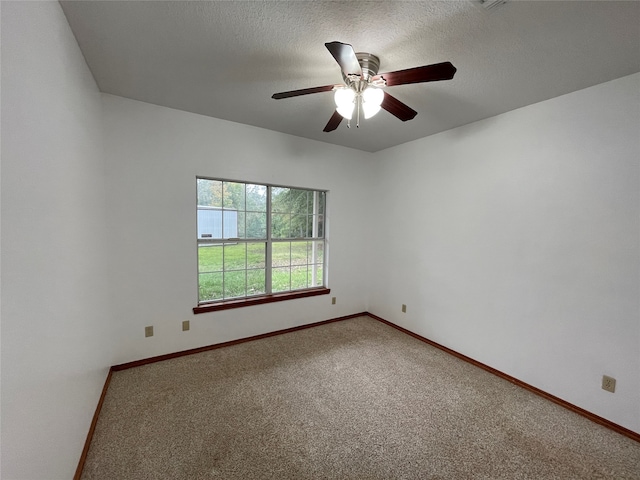 empty room with a textured ceiling, carpet flooring, and ceiling fan