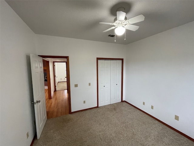 unfurnished bedroom with a closet, ceiling fan, and carpet flooring