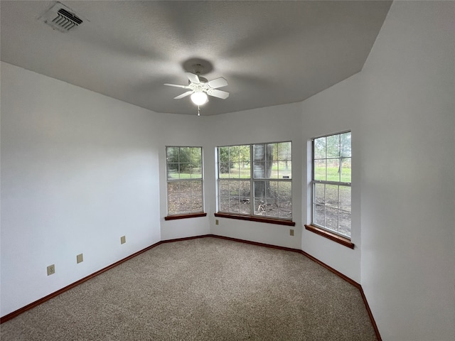 spare room featuring carpet flooring and ceiling fan