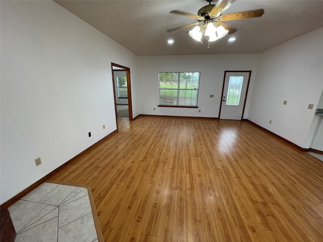 empty room featuring ceiling fan and light wood-type flooring