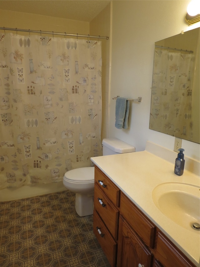 bathroom featuring toilet and vanity