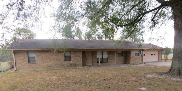 rear view of house with a lawn and a garage