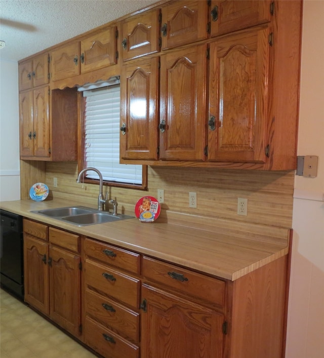 kitchen featuring dishwasher, tasteful backsplash, sink, and a textured ceiling