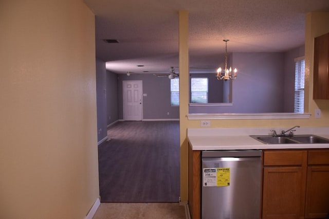 kitchen with sink, hanging light fixtures, stainless steel dishwasher, a textured ceiling, and ceiling fan with notable chandelier