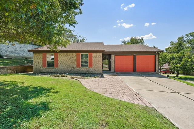 single story home featuring a front yard and a garage