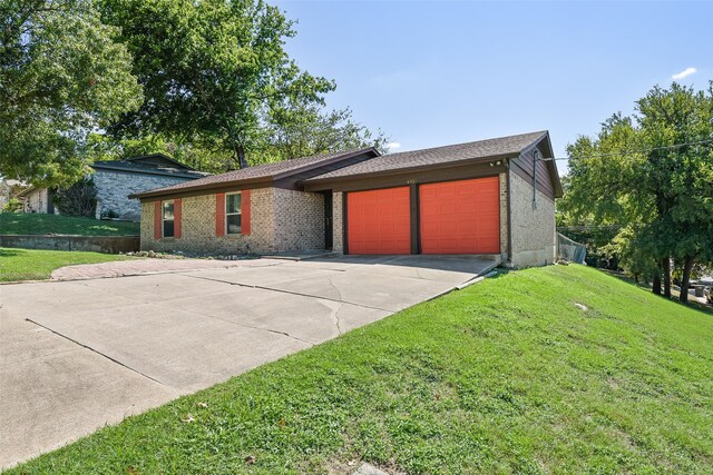 single story home featuring a front lawn and a garage