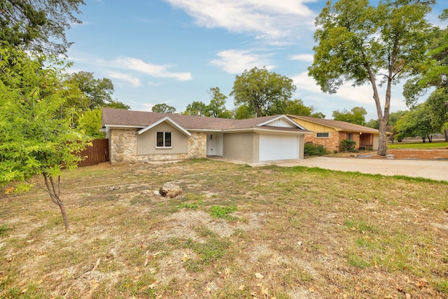 single story home with a front yard and a garage