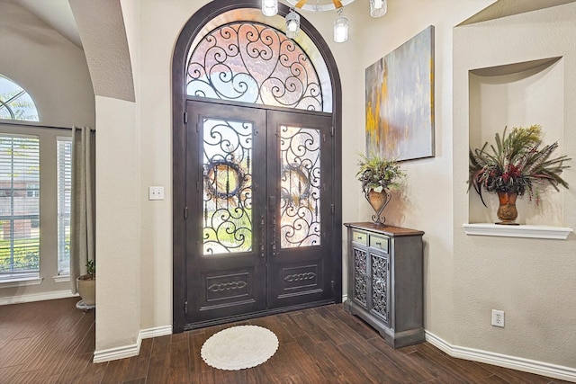 foyer with french doors and dark hardwood / wood-style floors