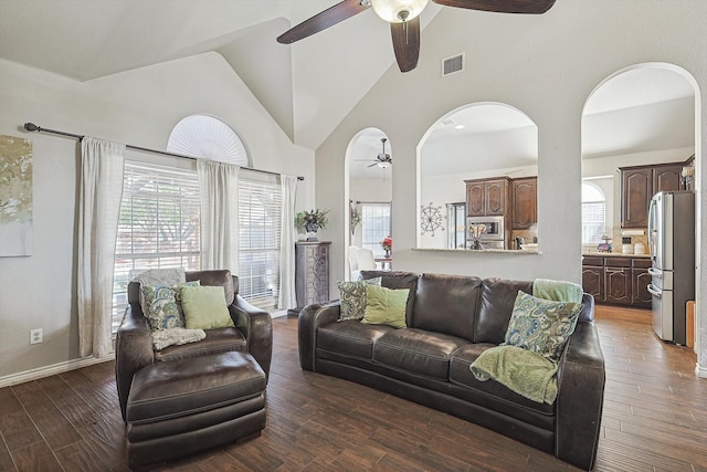 living room with ceiling fan, dark hardwood / wood-style floors, and high vaulted ceiling