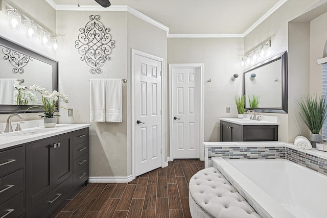 full bath with a sink, a bathtub, ornamental molding, and wood tiled floor