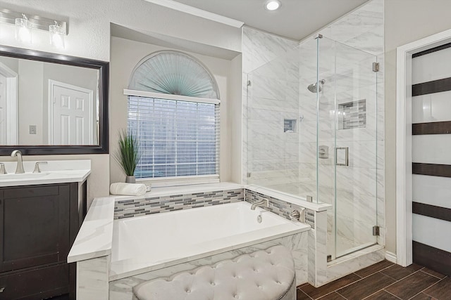 full bath with a bath, a shower stall, vanity, and wood tiled floor