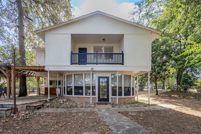 back of house featuring a sunroom and a balcony