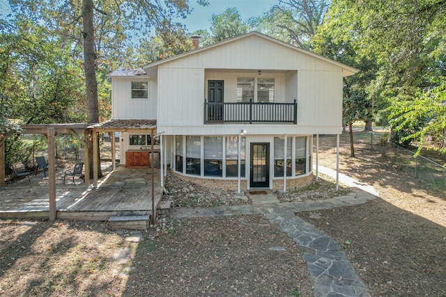 rear view of house with a wooden deck