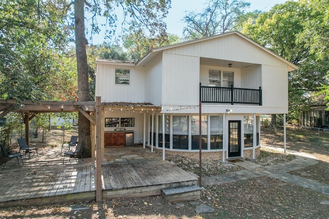 rear view of house featuring area for grilling and a deck