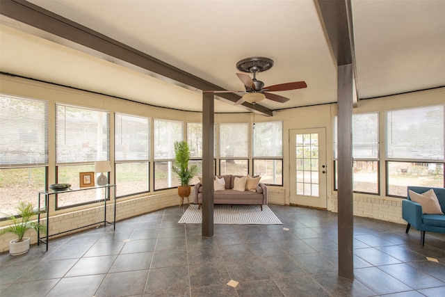 sunroom / solarium with beamed ceiling, ceiling fan, and a wealth of natural light