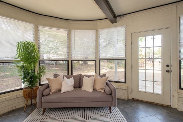 sunroom featuring beamed ceiling