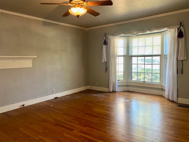 spare room with ornamental molding, hardwood / wood-style floors, and ceiling fan