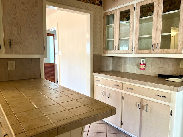 kitchen featuring tile countertops, decorative backsplash, light tile patterned flooring, and light brown cabinetry