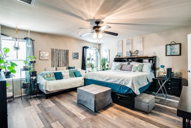 bedroom featuring wood-type flooring and ceiling fan