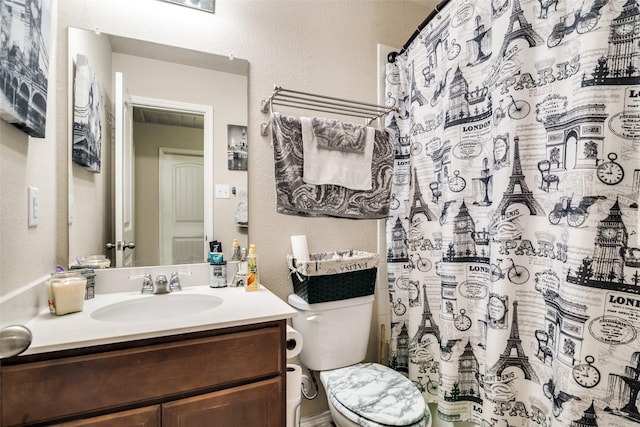 2209 Torch Lake Dr, Forney, TX 75126 - full bathroom featuring vanity, a textured wall, a shower with shower curtain, and toilet