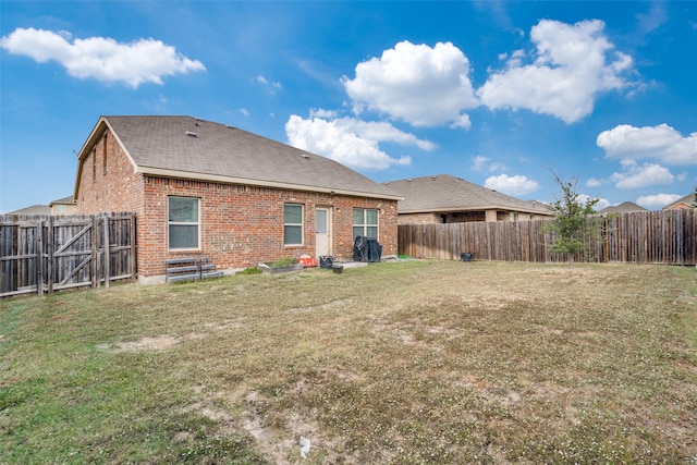 back of property featuring a yard