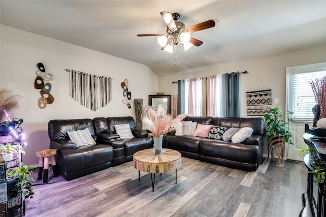 living room with ceiling fan, hardwood / wood-style flooring, and lofted ceiling