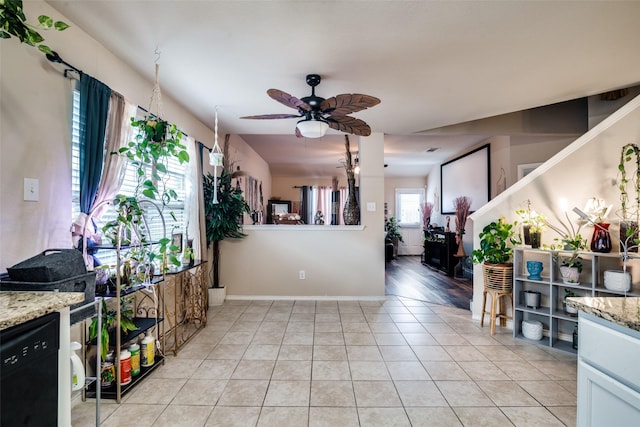 2209 Torch Lake Dr, Forney, TX 75126 - kitchen featuring baseboards, ceiling fan, light tile patterned flooring, and light stone countertops