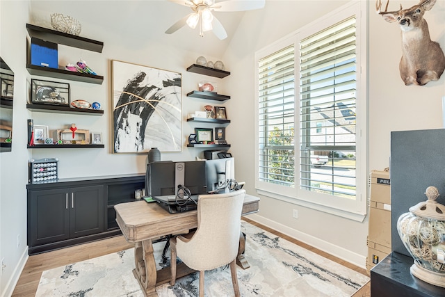 office area featuring lofted ceiling, ceiling fan, a healthy amount of sunlight, and light hardwood / wood-style floors