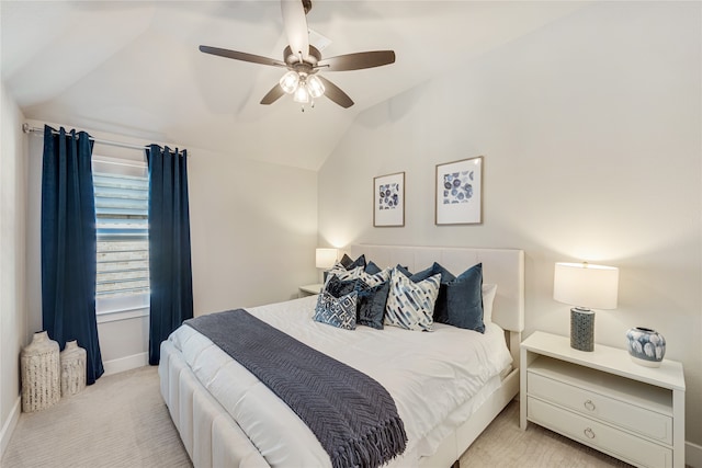 bedroom with ceiling fan, vaulted ceiling, and light colored carpet