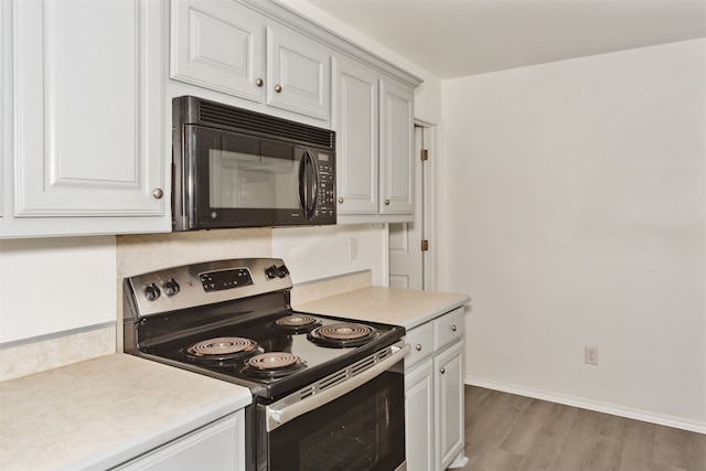 kitchen with stainless steel range with electric cooktop and light hardwood / wood-style floors