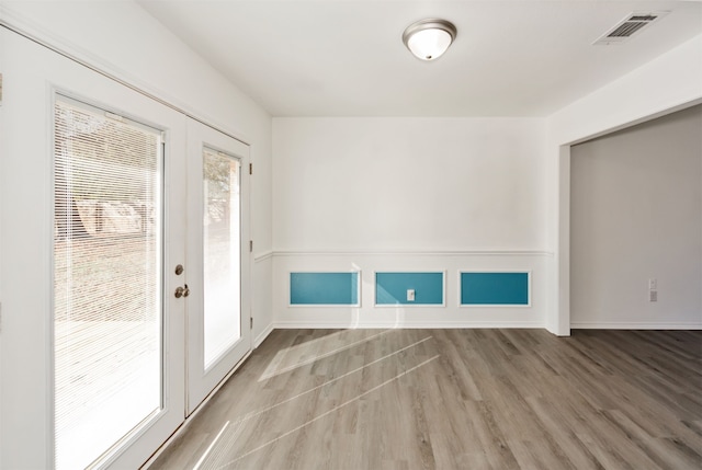 interior space with light hardwood / wood-style floors and french doors