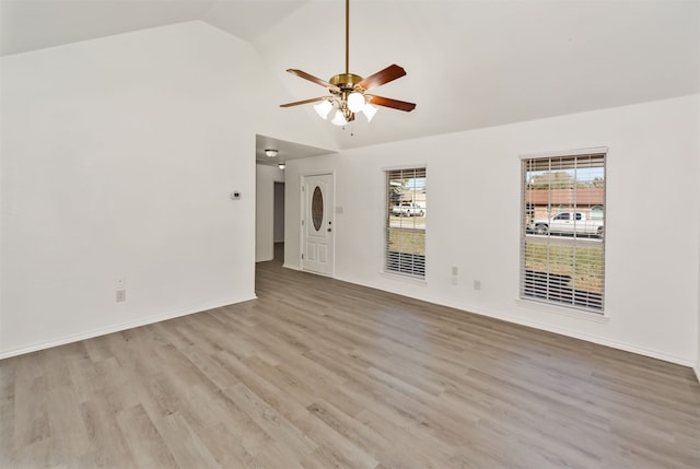 empty room featuring ceiling fan, high vaulted ceiling, and light wood-type flooring