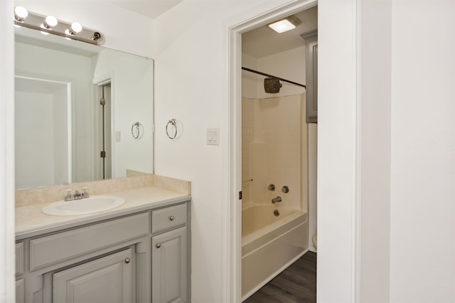 bathroom featuring vanity, shower / bathing tub combination, and hardwood / wood-style floors