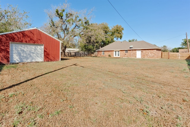 view of yard with an outdoor structure and a garage