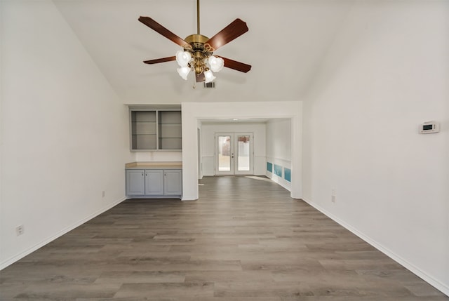 unfurnished living room featuring french doors, wood-type flooring, lofted ceiling, and ceiling fan