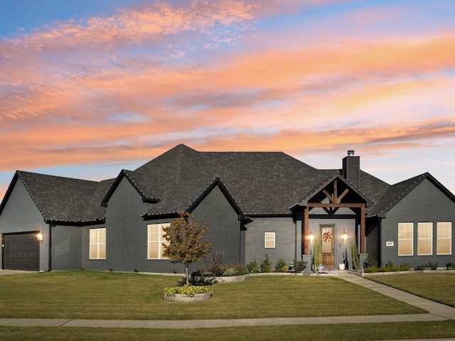 view of front facade with a lawn and a garage