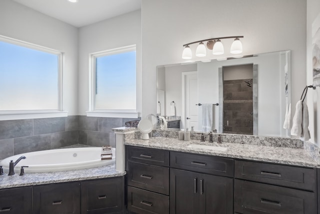 bathroom featuring plus walk in shower and vanity